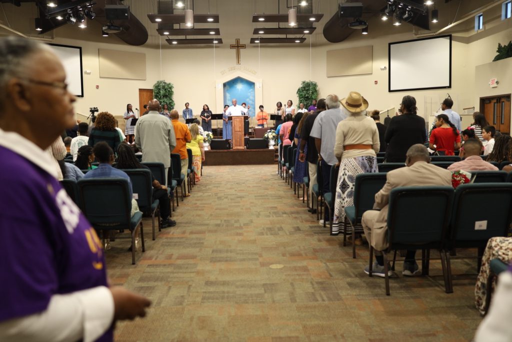 Genesis Full Life Fellowship Church congregation standing in worship